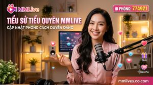 Banner tiểu sử Tiểu Quyên MMLive, cập nhật phong cách duyên dáng với ID phòng 774921. Hình ảnh nữ streamer xinh đẹp mỉm cười rạng rỡ đang ngồi trước micro trong không gian phòng live ấm áp, kèm các biểu tượng tương tác ảo và tên miền nanogate.io.